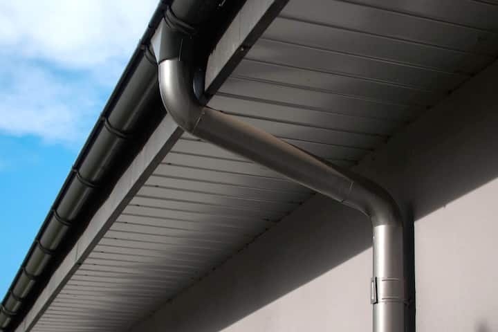 Corrosion-resistant galvanized gutters installed on a commercial building in Syracuse